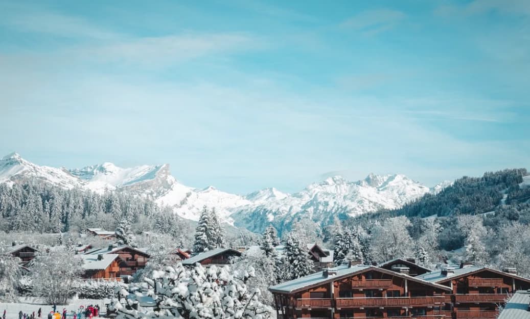 Snow-covered chalets of Les Gets facing the mountain panorama